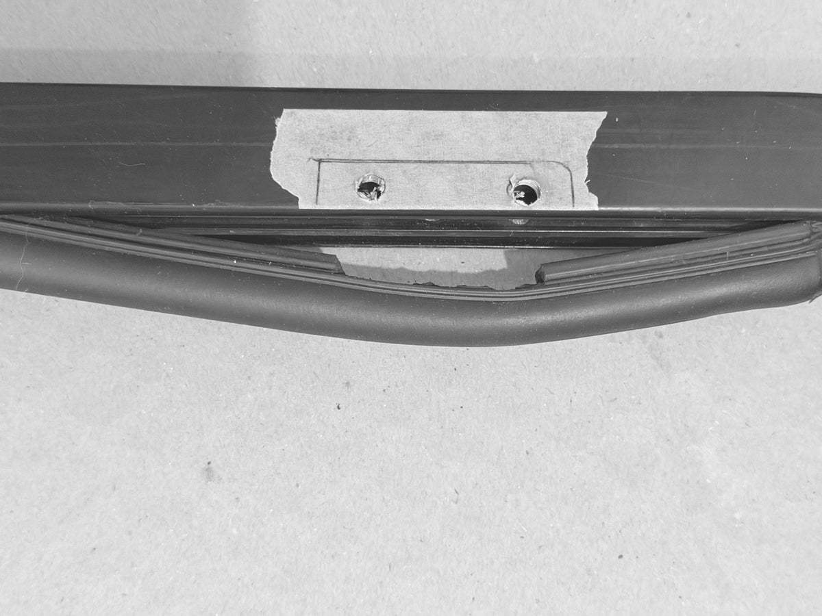 Drilling holes in the original door jamb to install the hinges