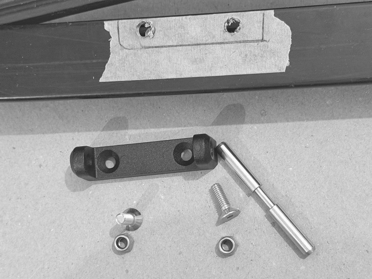 Drilling holes in the original door jamb to install the hinges and mounting hardware